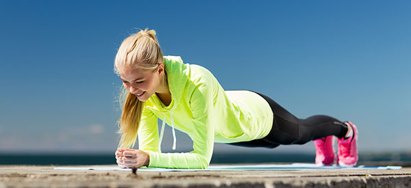 Women performing a a plank exercise as part of an exercise rehabilitation prom\gram