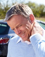 Older man rubbing an aching neck